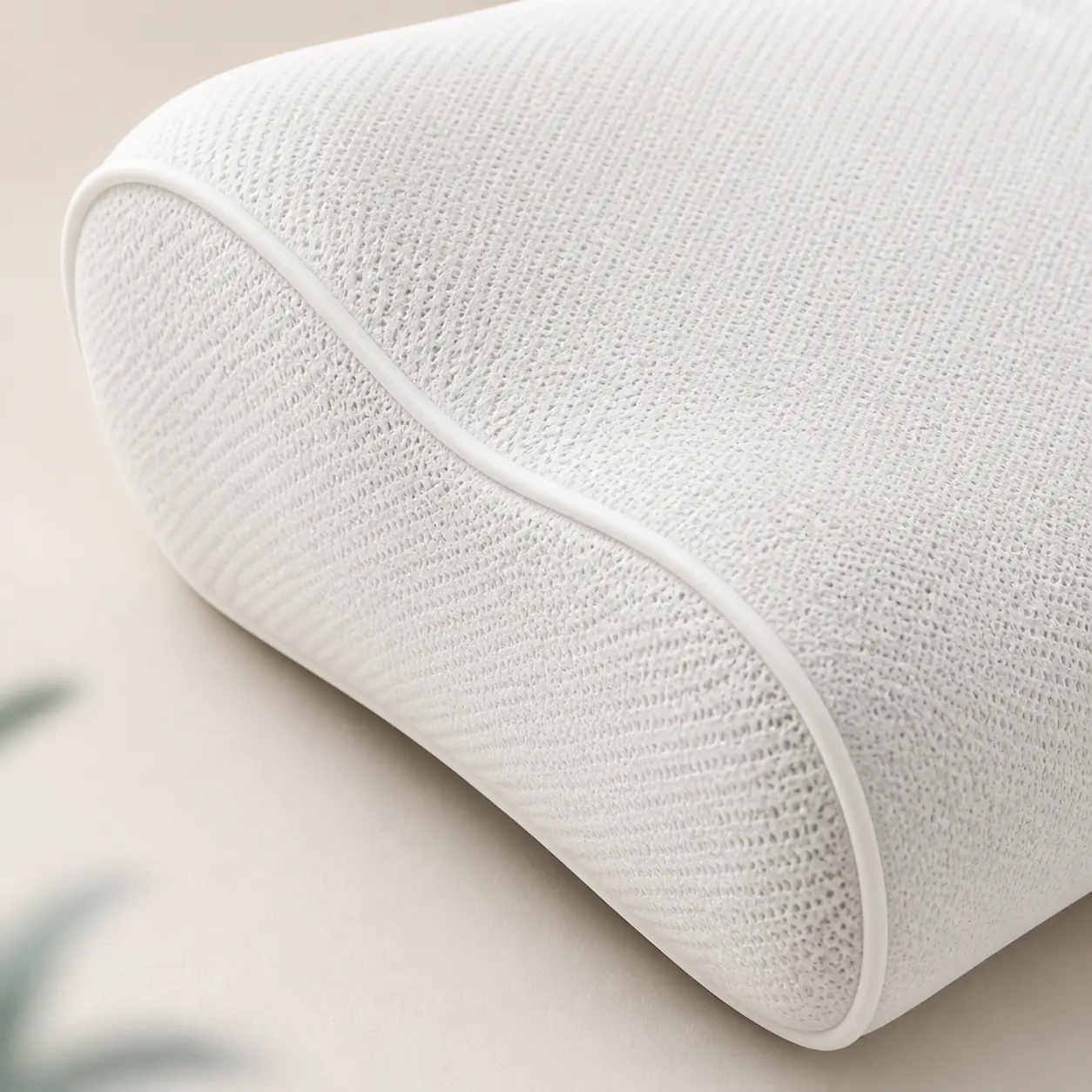 Close view of the textured fabric and piped edge of an Ovio pillow