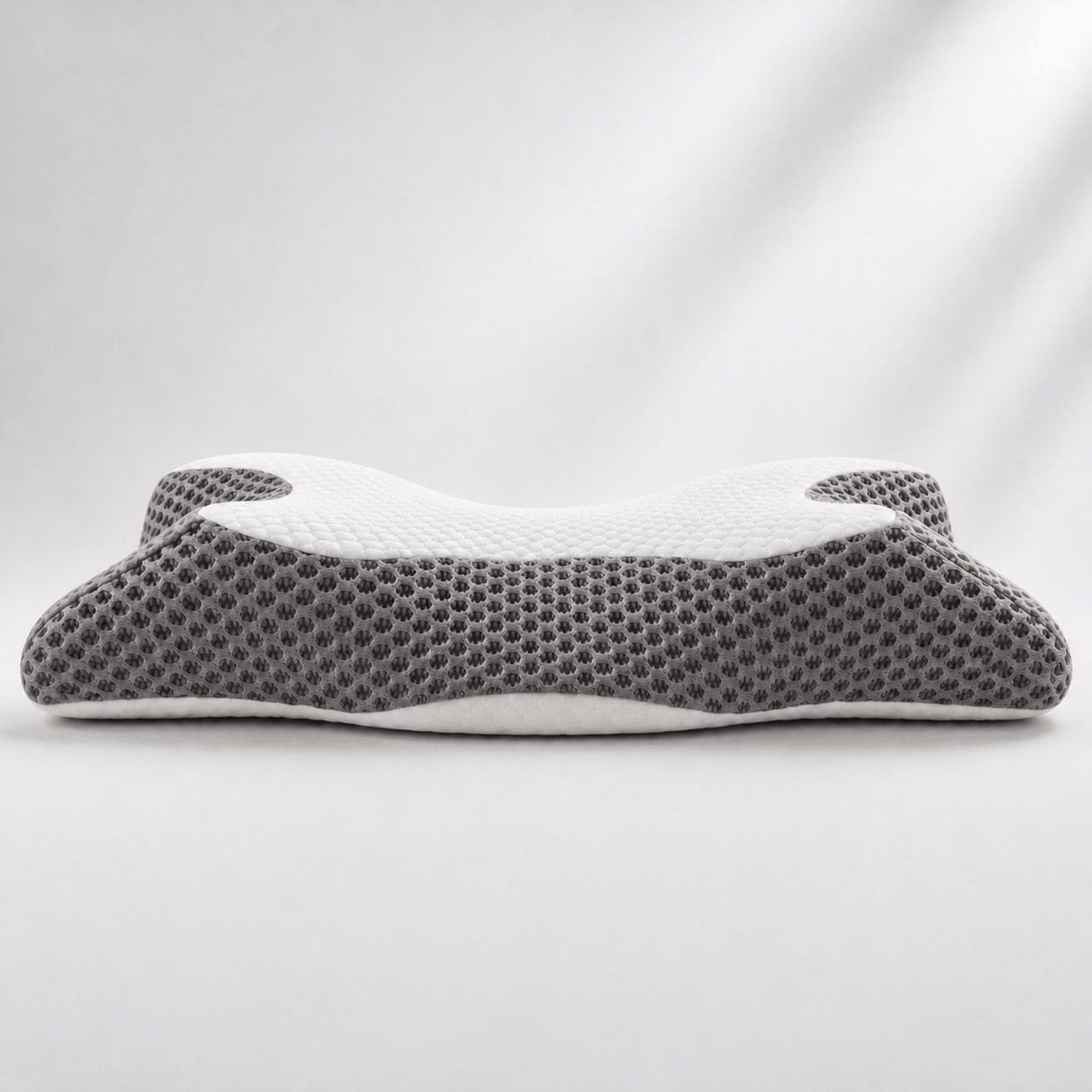 Side profile of the OrthoCloud Pillow showing its dual-height ergonomic contour