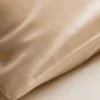 Close-up of Champagne mulberry silk fabric and pillowcase seam