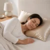 Woman sleeping on a Champagne Ovio Mulberry Silk Pillowcase in a neutral bedroom
